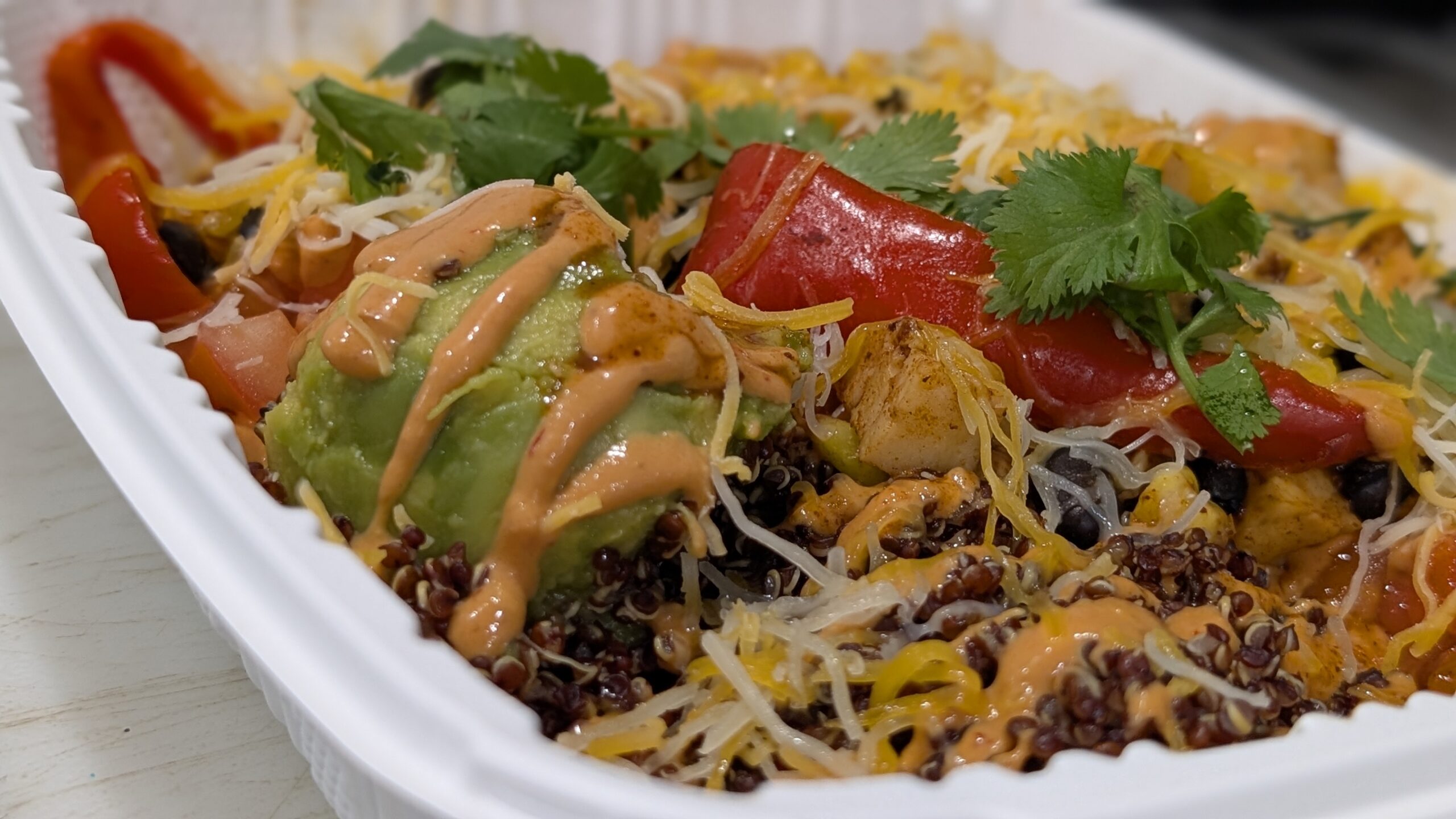 Sliced chicken shawarma served with hummus, cucumber tomato salad, and brown rice.